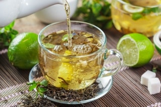 cup black tea with mint leaves wooden table 320